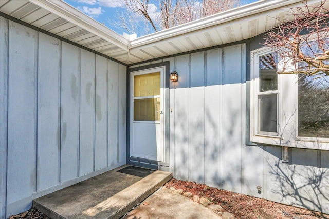 view of exterior entry with board and batten siding