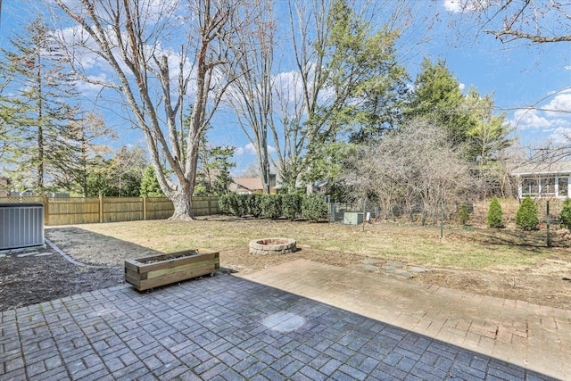 view of patio / terrace with central air condition unit, fence, and an outdoor fire pit