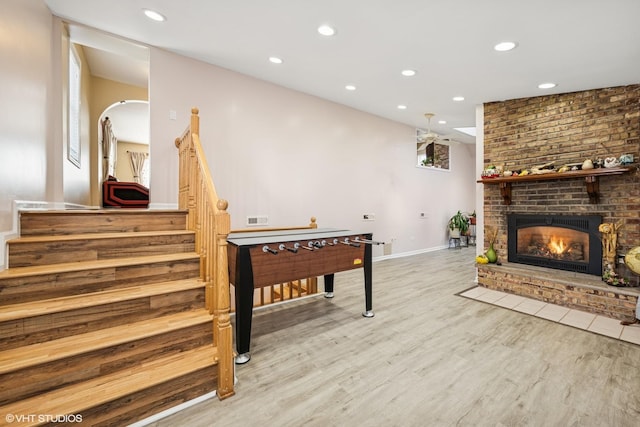 playroom featuring visible vents, wood finished floors, recessed lighting, a fireplace, and baseboards