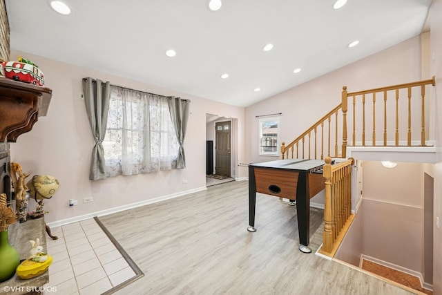 recreation room featuring a wealth of natural light, wood finished floors, recessed lighting, and vaulted ceiling