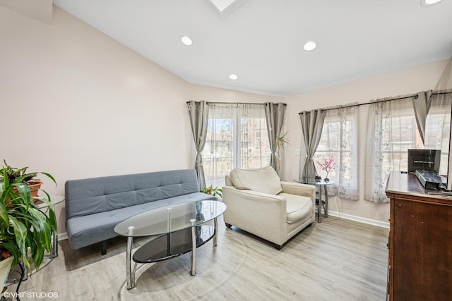 living room featuring lofted ceiling, recessed lighting, baseboards, and light wood finished floors