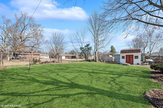 view of yard with an outdoor structure and fence