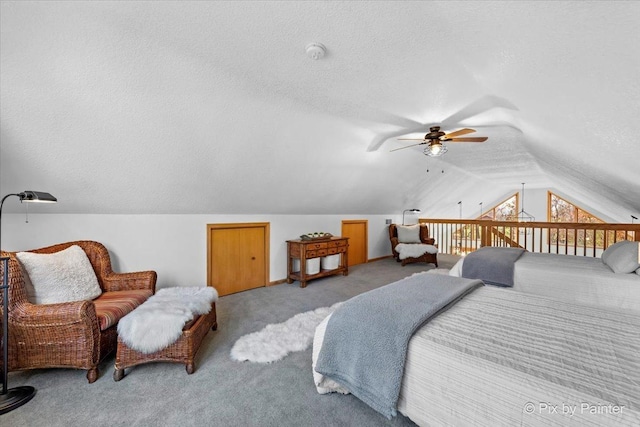 bedroom with lofted ceiling, light carpet, and a textured ceiling