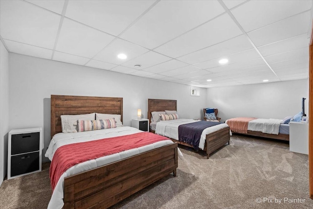 carpeted bedroom with recessed lighting and a paneled ceiling