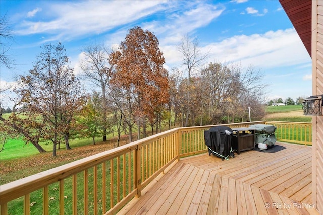 wooden terrace featuring a yard