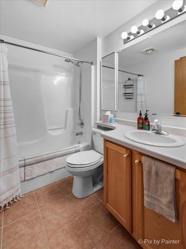 bathroom featuring vanity, tile patterned flooring, shower / bath combo with shower curtain, a textured ceiling, and toilet