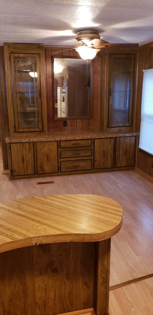 interior space with a textured ceiling and wood finished floors