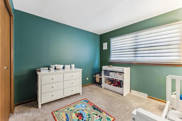 bedroom with light carpet, visible vents, and baseboards