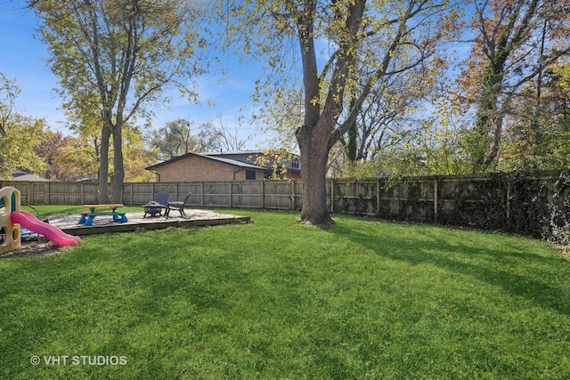 view of yard featuring a fenced backyard and a playground