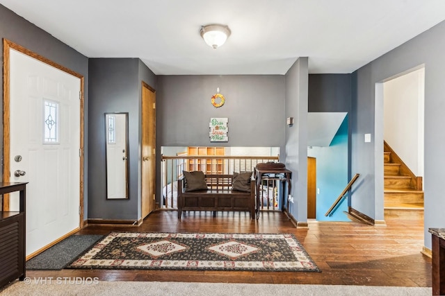 foyer featuring hardwood / wood-style flooring and baseboards