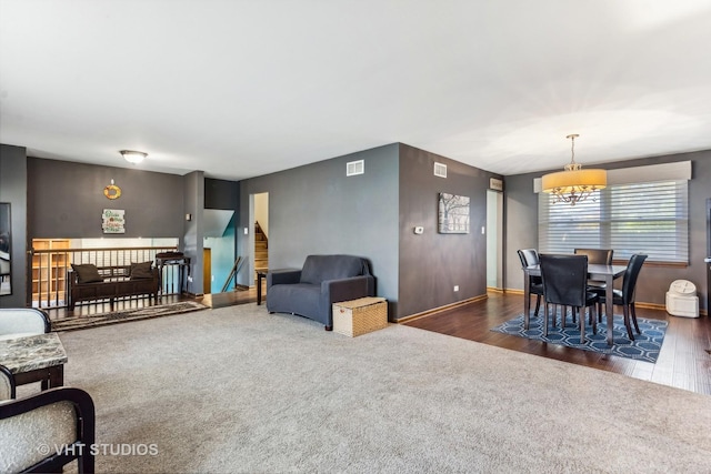 living room with dark colored carpet, dark wood finished floors, and baseboards