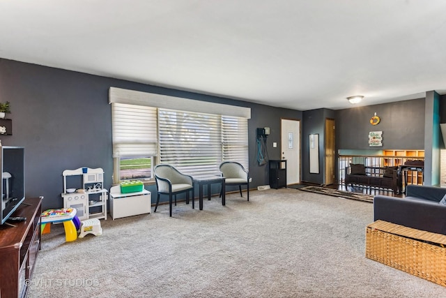 carpeted living area featuring baseboards