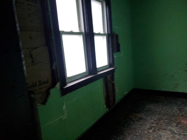 empty room featuring a paneled ceiling and radiator