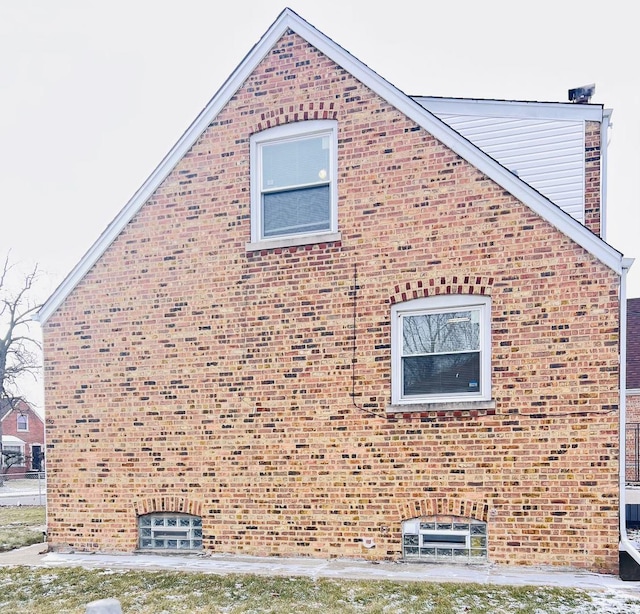 view of side of home featuring brick siding