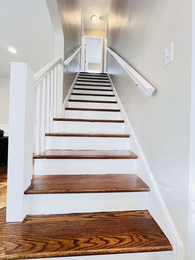 staircase featuring recessed lighting