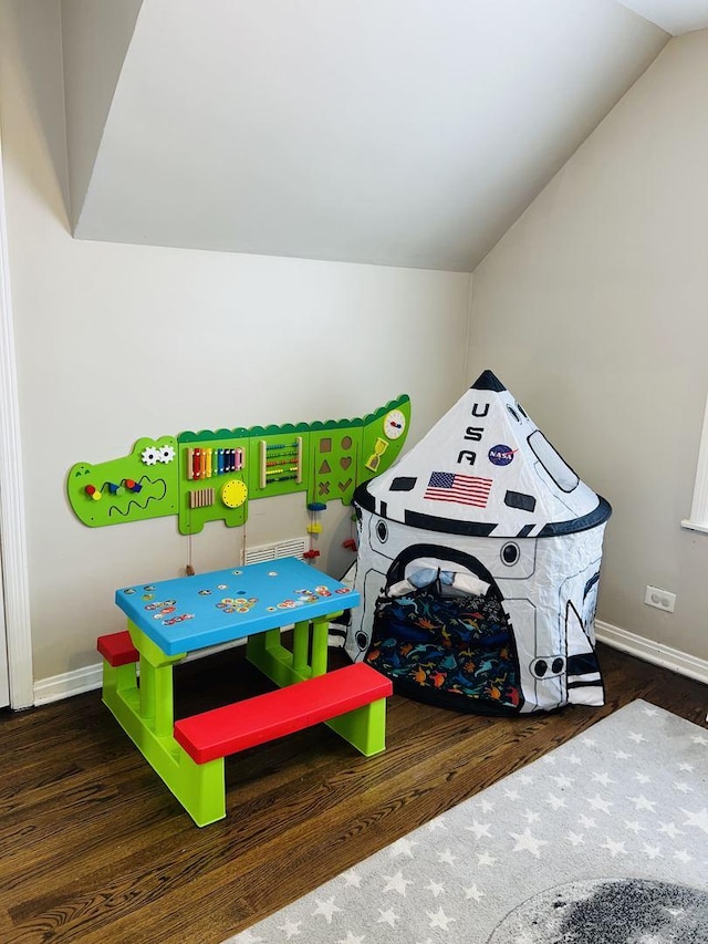 playroom featuring lofted ceiling, baseboards, and wood finished floors