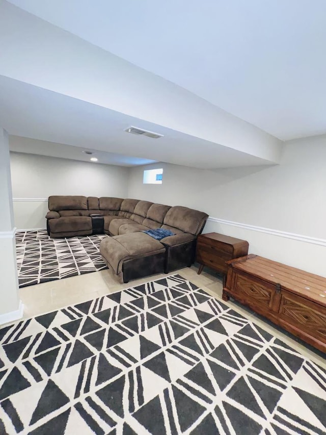 unfurnished living room with carpet, visible vents, and baseboards