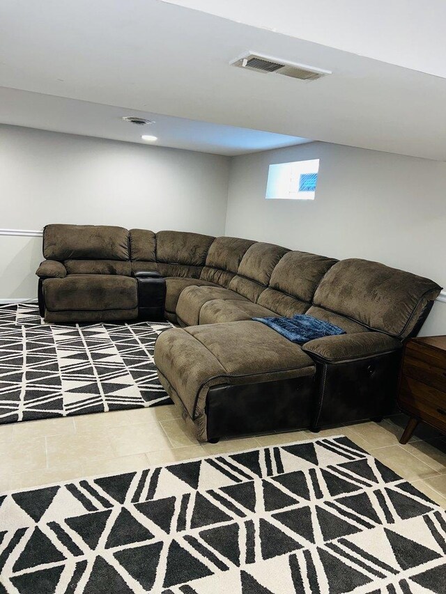 living area featuring tile patterned flooring and visible vents