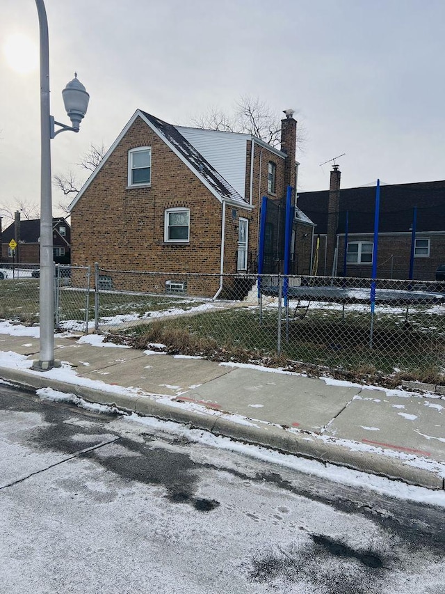 exterior space with fence and brick siding