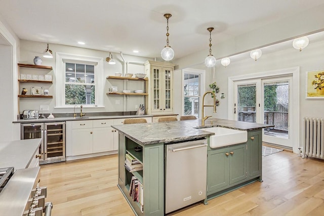 kitchen featuring radiator, green cabinets, and open shelves