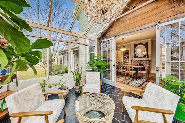 sunroom featuring vaulted ceiling and a healthy amount of sunlight