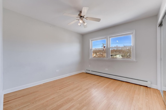 unfurnished room with light wood finished floors, ceiling fan, a baseboard heating unit, and baseboards