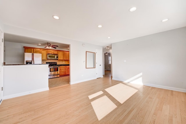 unfurnished living room with recessed lighting, baseboards, ceiling fan, and light wood finished floors