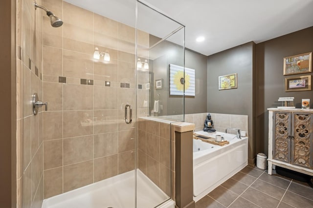 bathroom featuring tile patterned floors, a bath, and a shower stall