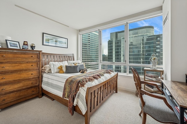 bedroom featuring a city view and light carpet