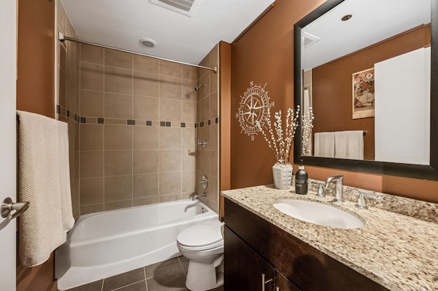 bathroom with vanity, visible vents, tile patterned flooring, bathtub / shower combination, and toilet