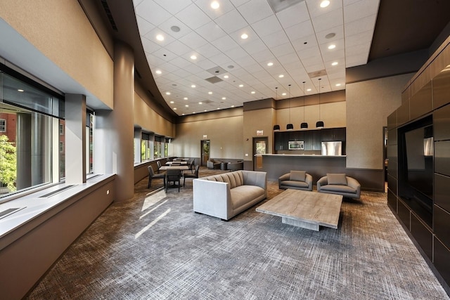 interior space featuring recessed lighting, carpet floors, and a towering ceiling