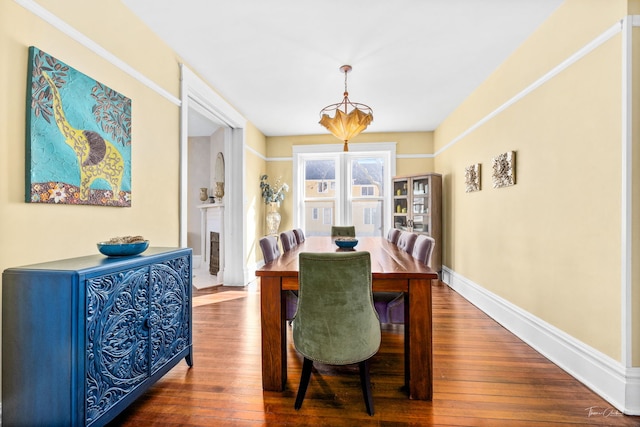 dining area with baseboards and hardwood / wood-style flooring