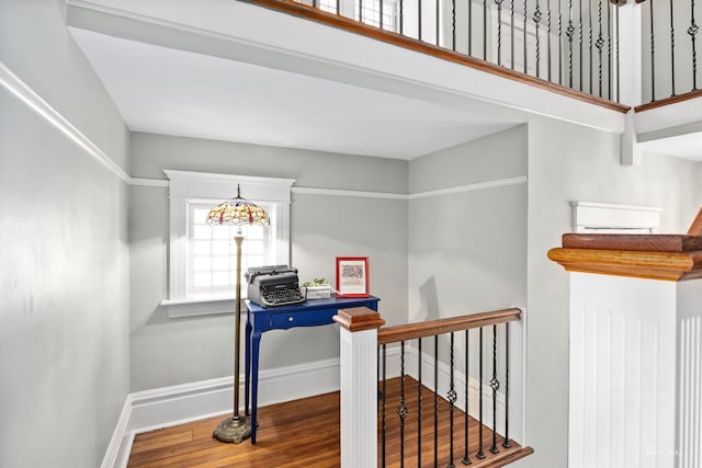 interior space with baseboards and wood finished floors