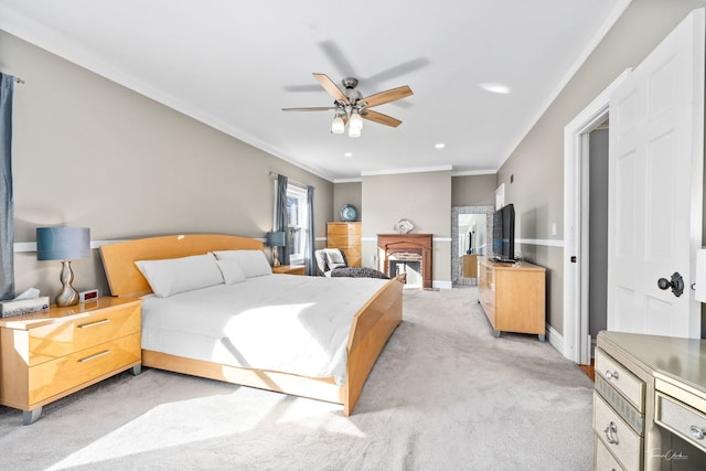 bedroom with a fireplace, recessed lighting, ornamental molding, light carpet, and baseboards