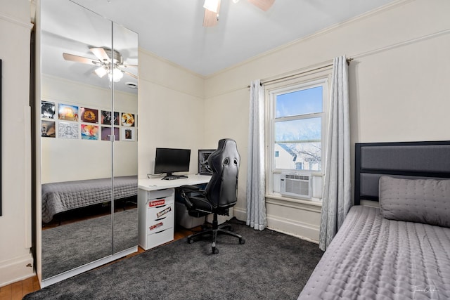 carpeted office featuring a ceiling fan, baseboards, ornamental molding, and cooling unit