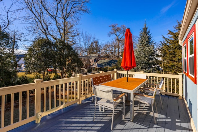 wooden deck featuring outdoor dining area