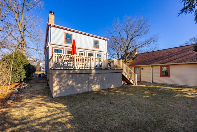 back of property featuring stairway, a lawn, a chimney, and a deck