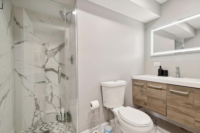 bathroom featuring toilet, a marble finish shower, and vanity