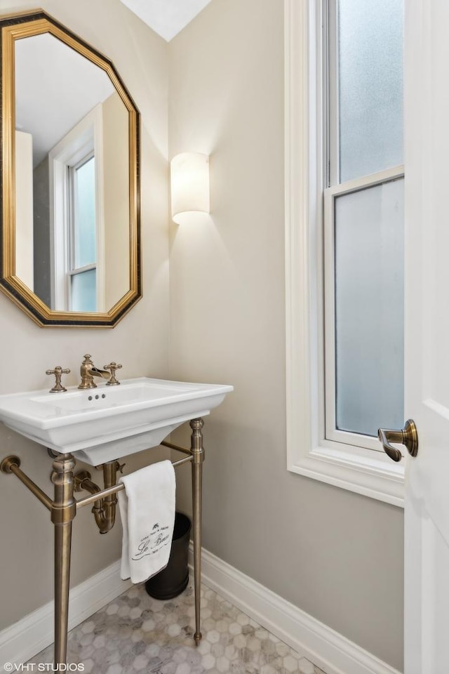 bathroom with baseboards and tile patterned floors