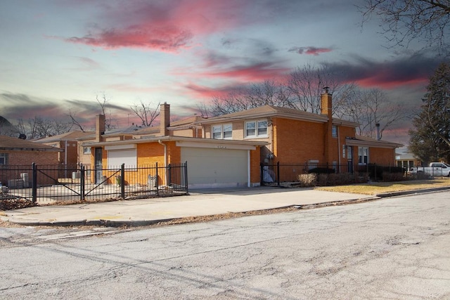 view of front of home featuring driveway, a chimney, fence, and brick siding