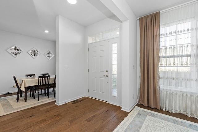 foyer with dark wood-style floors, recessed lighting, and baseboards