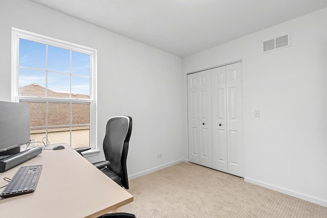 office featuring light carpet, baseboards, and visible vents