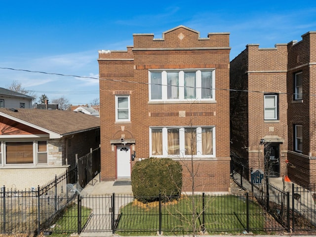 view of front of house with a fenced front yard and brick siding