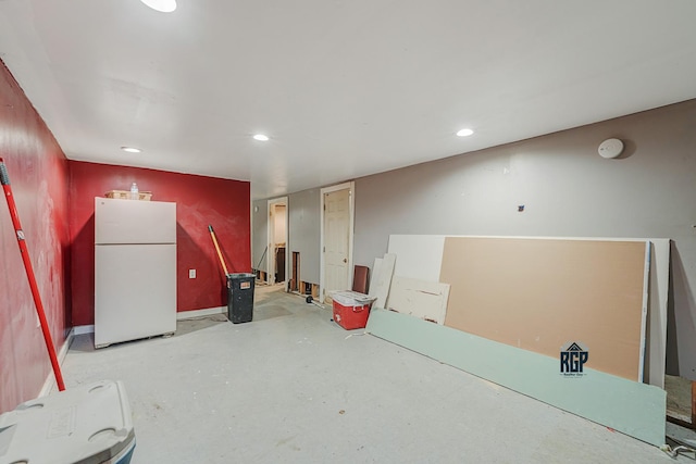 interior space with freestanding refrigerator and recessed lighting