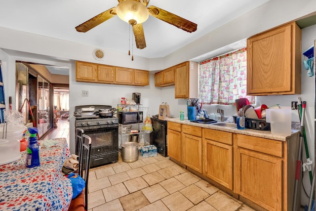 kitchen with ceiling fan, a sink, light countertops, brown cabinets, and black appliances