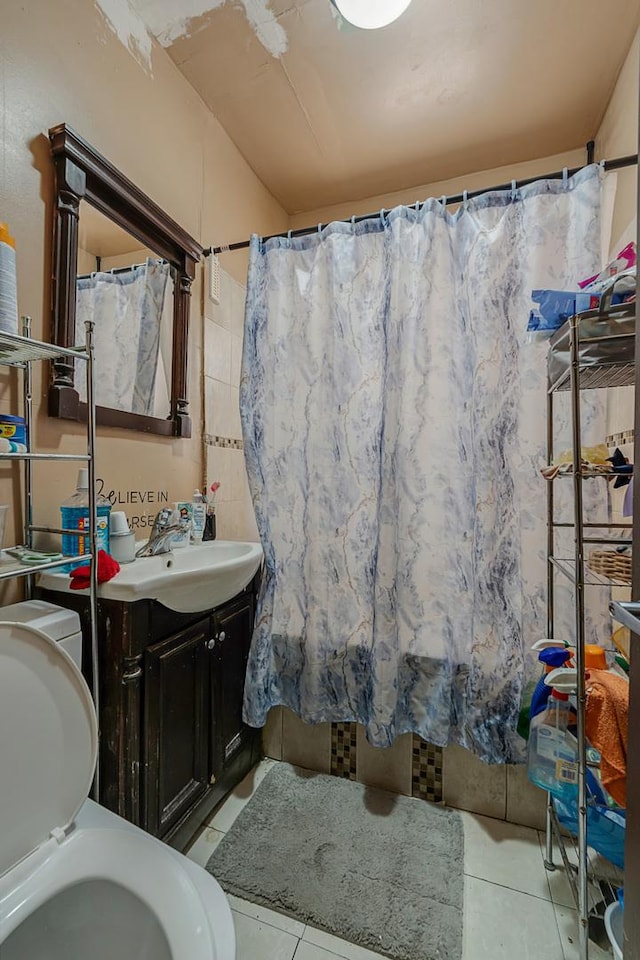 full bath with a shower with curtain, tile patterned flooring, and vanity