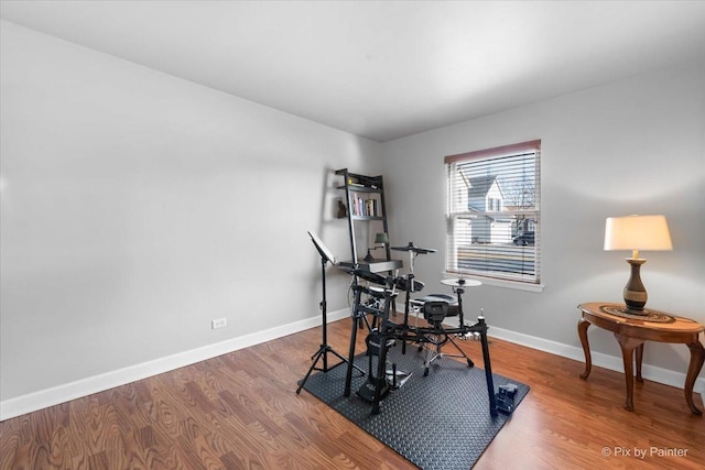 interior space featuring baseboards and wood finished floors