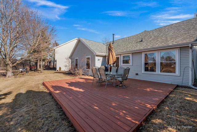 wooden deck featuring a yard and outdoor dining space