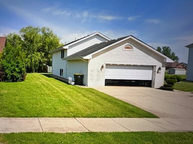 single story home with a garage, a front yard, brick siding, and driveway