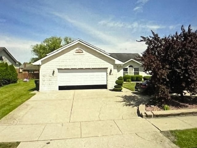 ranch-style house with driveway, a garage, and a front lawn